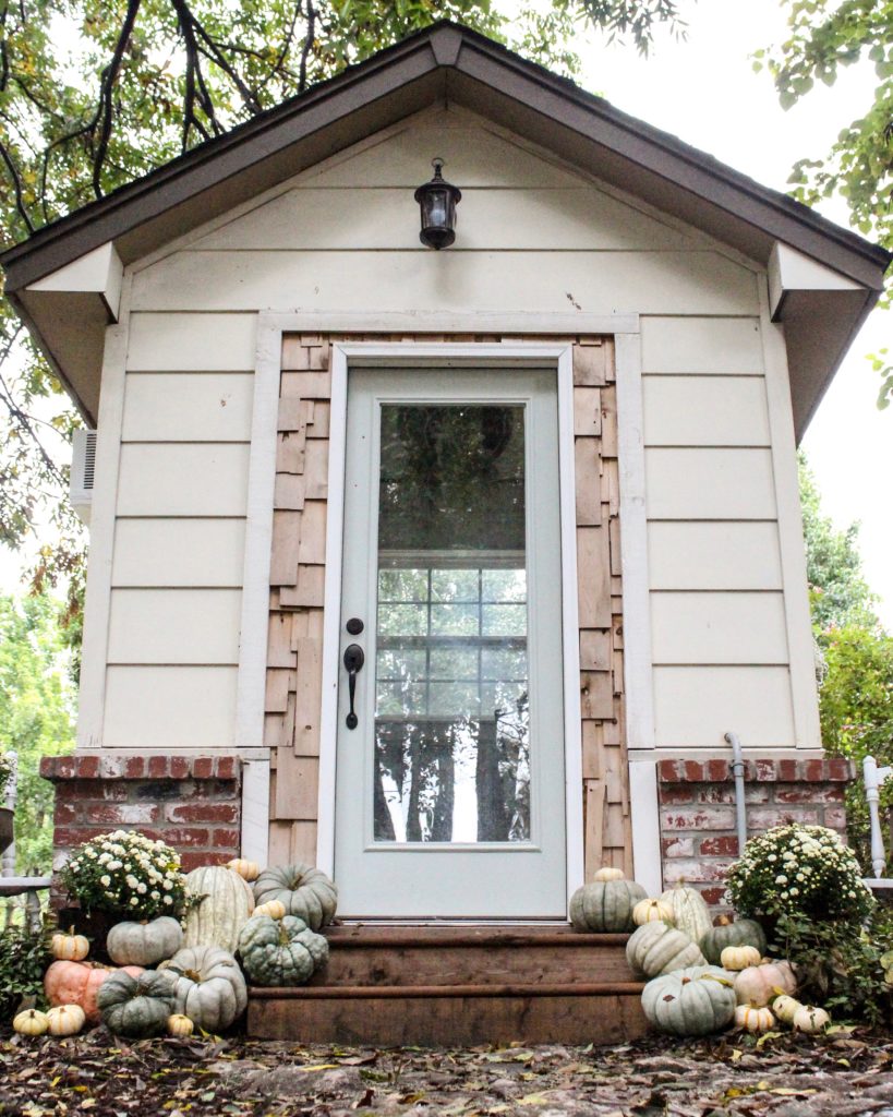 CottonStem.com farmhouse style she shed tiny home office pumpkins and mums front porch steps